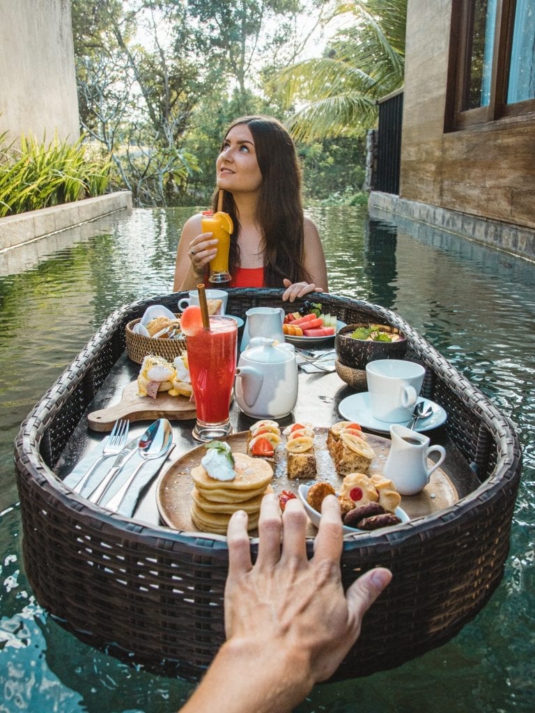 Woman eating floating breakfast at Wyndham Dreamland Resort Bali