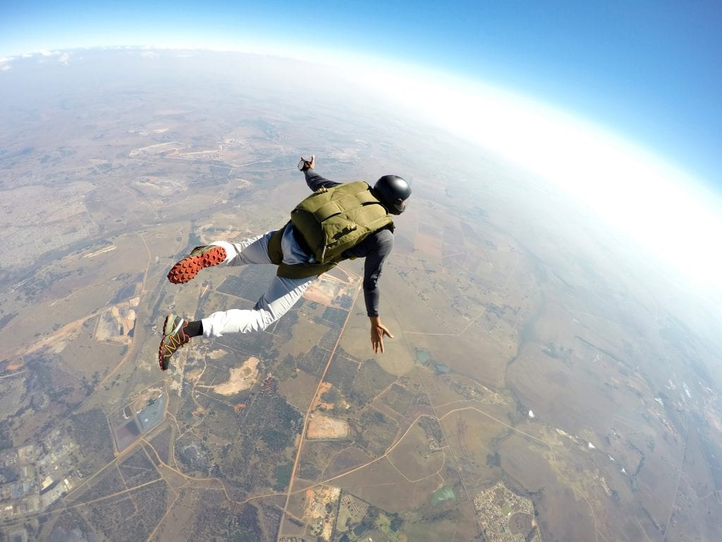 Man sky diving above earth